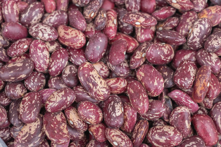 Top view of dried red beans with white spots, close-up, background for product design in the store...