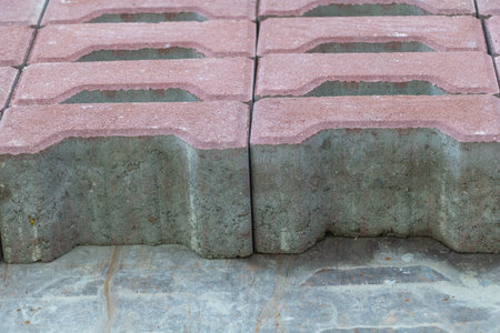 Closeup of red and gray concrete paving blocks arranged in stack, construction materials for sidewalk and outdoor landscaping.の写真素材