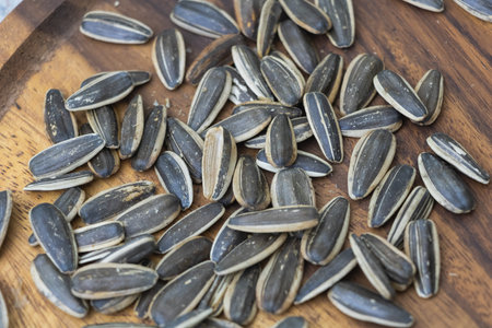 Sunflower seeds on wooden surface - healthy snack.