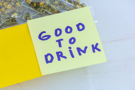 Good to drink handwritten message on sticky note about chamomile tea.の写真素材