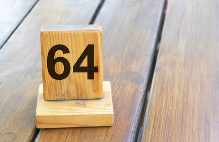 Wooden priority number 64 on a plank tab.の写真素材
