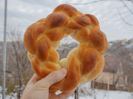 Braided Bread Ring Held in Hand - Fresh Homemade Pastry Outdoor