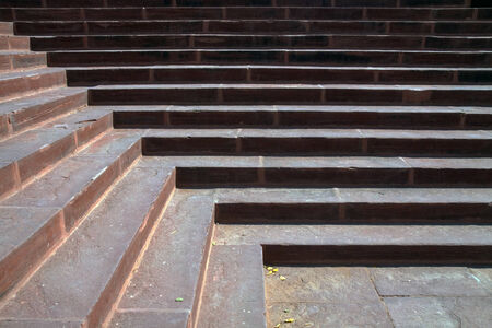 morning sunlight on red sandstone stairs creates light and shadow design in linesの写真素材