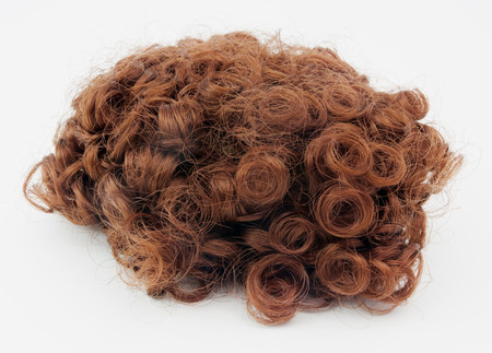 Reddish brown wig with curls.の写真素材