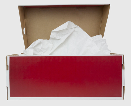 Front view of red and white shoebox with tissue paper. isolated.の写真素材