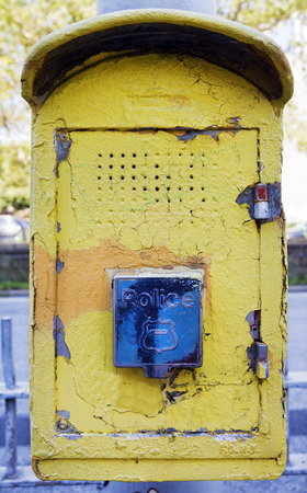 Old weathered yellow New York City police call box.の写真素材