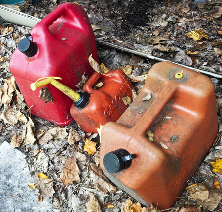 Got gas? Above view of three well-used gas containers on ground.の写真素材