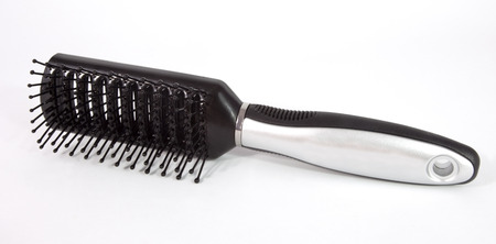 Isolated black hairbrush with shiny silver accents.の写真素材