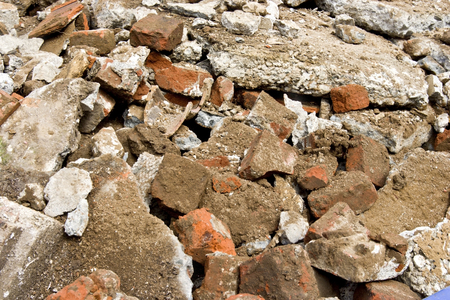 Pile of construction rubble: brick, cement, concrete and dirt.