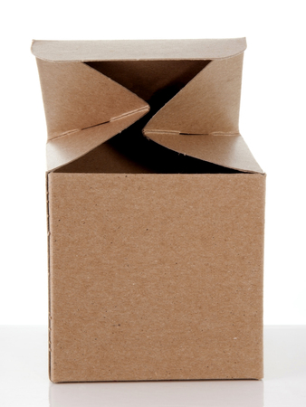 Small open cardboard gift box without wrapping on a reflective surface.