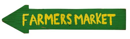 Isolated handmade arrow shaped yellow and green FARMERS MARKET sign.の写真素材
