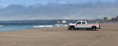 Ocean Beach, San Francisco, with emergency rescue vehicle on patrol.の写真素材