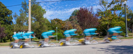 Motion blur team bike race through residential neighborhood.の写真素材