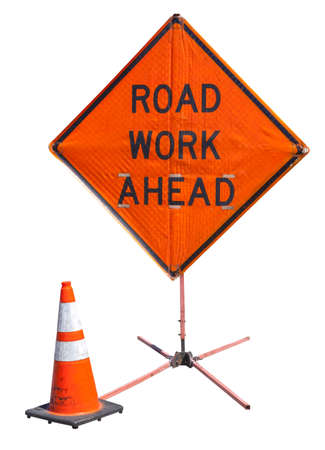 Bright orange ROAD WORK AHEAD sign with safety cone. Isolated.の写真素材