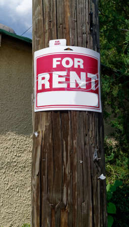 FOR RENT sign stapled to telephone pole. Copy space on the sign.の写真素材
