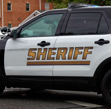 Side view of Sheriff`s car door with SHERIFF text symbol.の写真素材