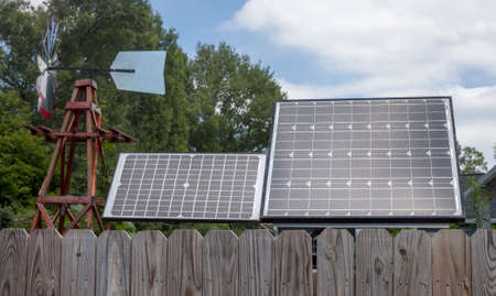 Wind and solar power generation in residential neighborhood yard.