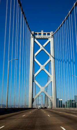 Crossing the older section of Oakland-San Francisco Bay Bridge under blue sky. Vertical.の写真素材