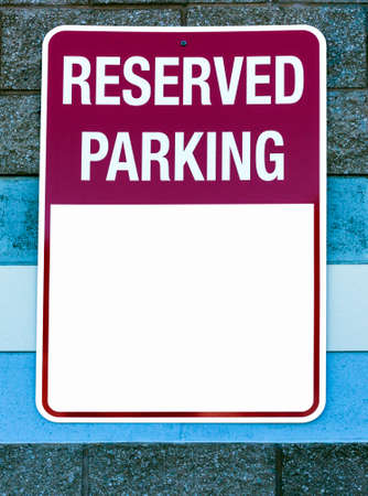 RESERVED PARKING sign attached to wall with white copy space.の写真素材