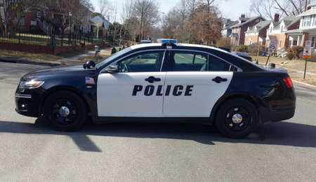 Police car barricade on residential neighborhood street.の写真素材