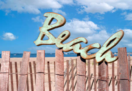 welcome to the beach sign mounted on sand dune fenceの写真素材