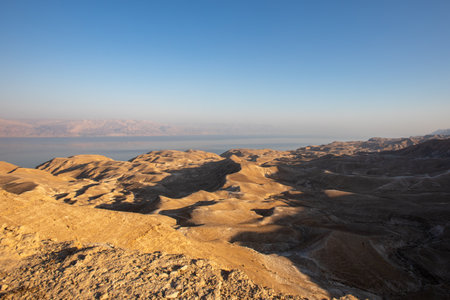 Beautiful landscape of Israeli Judean Desert mountains, with sunrise over the dry riverbed of Nahal...