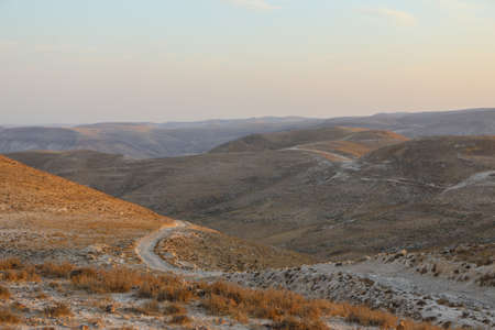 Mountain landscape against the backdrop of a fiery red sunsetの写真素材