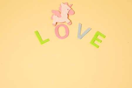Valentines day concept with letters love and wooden heart. Decor in shape of word LOVE. white letters. Valentine concept. Color of the year 2022. Very peri tint. Selective focus.の写真素材