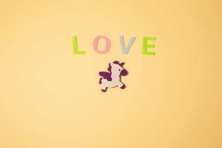 Valentines day concept with letters love and wooden heart. Decor in shape of word LOVE. white letters. Valentine concept. Color of the year 2022. Very peri tint. Selective focus.の写真素材