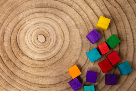 Colorful small wood block in many shape on wood texture background.の写真素材