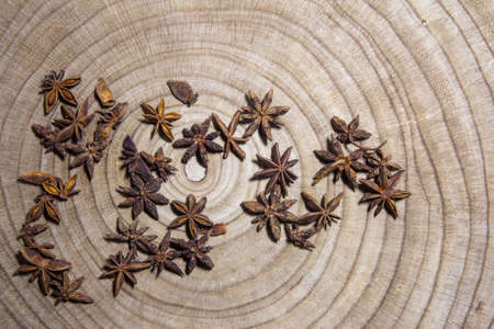 Dry anise stars on wooden table. Anise stars close up backgroundの写真素材