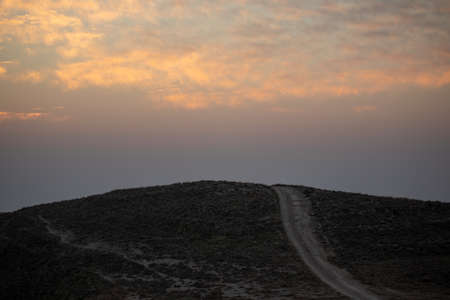 mountain silhouette in the desert at sunset sunriseの写真素材