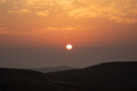 mountain silhouette in the desert at sunset sunriseの写真素材