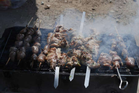 Cooking lamb skewers on the barbecue in nature. Cooking shashlik on the mangal. Cooking meat on charcoal.の写真素材