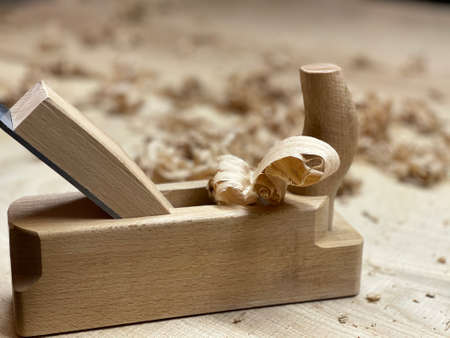 Chisel and small block plane with wood shavings. Carpenter cabinet maker hand tools on the...
