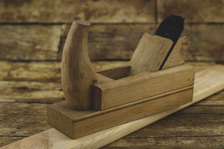 Chisel and small block plane with wood shavings. Carpenter cabinet maker hand tools on the...