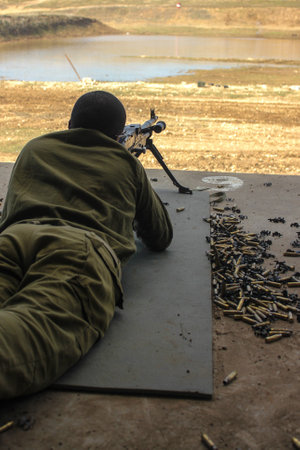 A soldier fires a machine gun High qualityの写真素材