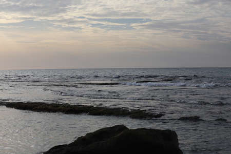 Sea landscape. Surfline with waves and foam at sunset time. Nature background