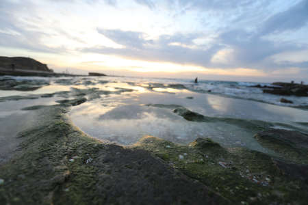 Sea landscape. Surfline with waves and foam at sunset time. Nature background
