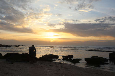 Man alone in the sea lonely feeling sunset time