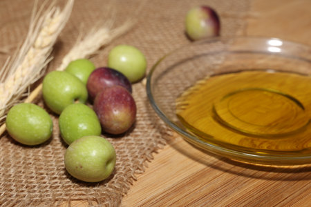 Olives and Olive Oil on wooden backgroundの写真素材
