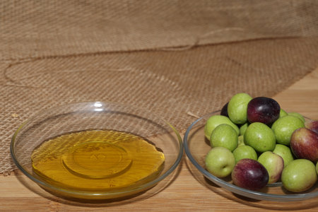 Olives and Olive Oil on wooden backgroundの写真素材