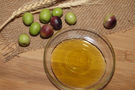 Olives and Olive Oil on wooden backgroundの写真素材