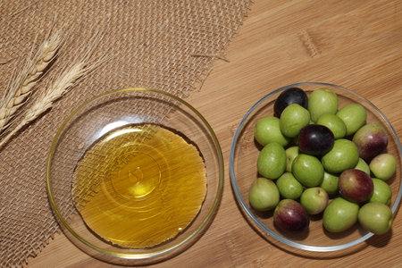 Olives and Olive Oil on wooden backgroundの写真素材