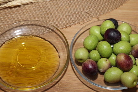 Olives and Olive Oil on wooden backgroundの写真素材