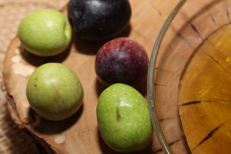 Olives and Olive Oil on wooden backgroundの写真素材