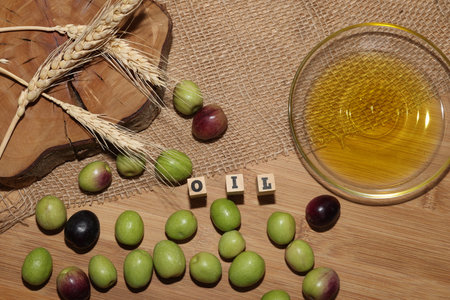 Olives and Olive Oil on wooden backgroundの写真素材