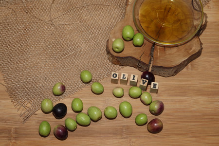 Olives and Olive Oil on wooden backgroundの写真素材