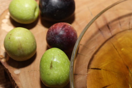 Olives and Olive Oil on wooden backgroundの写真素材