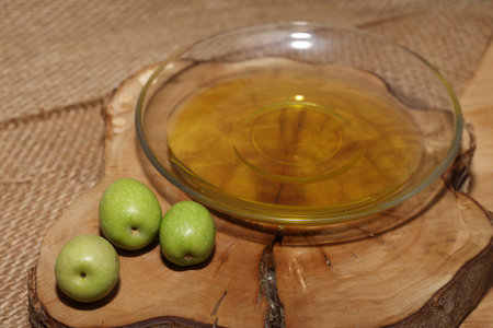 Olives and Olive Oil on wooden backgroundの写真素材